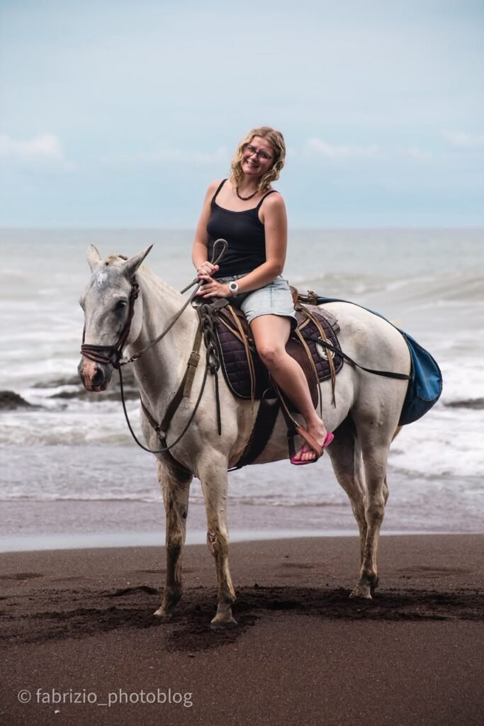 Horseback riders beside Jacó Beach on Costa Rica's Pacific coast