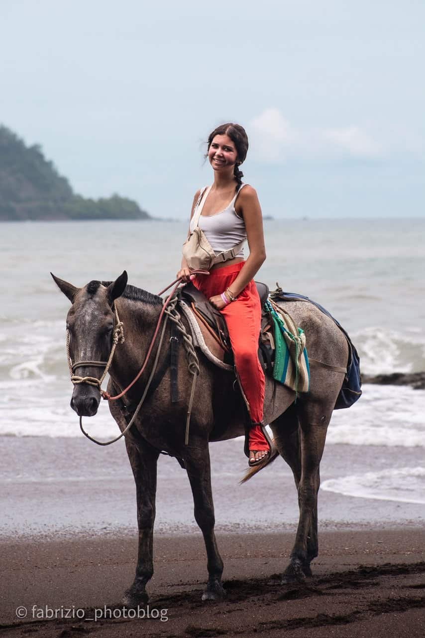 Guest riding a horse by the Pacific coast near Jacó
